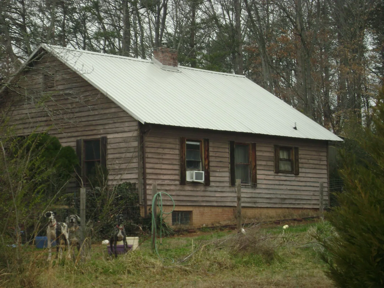 White metal roof on an old wood sided farmhouse, from a Metal Roof Installation job in Hague